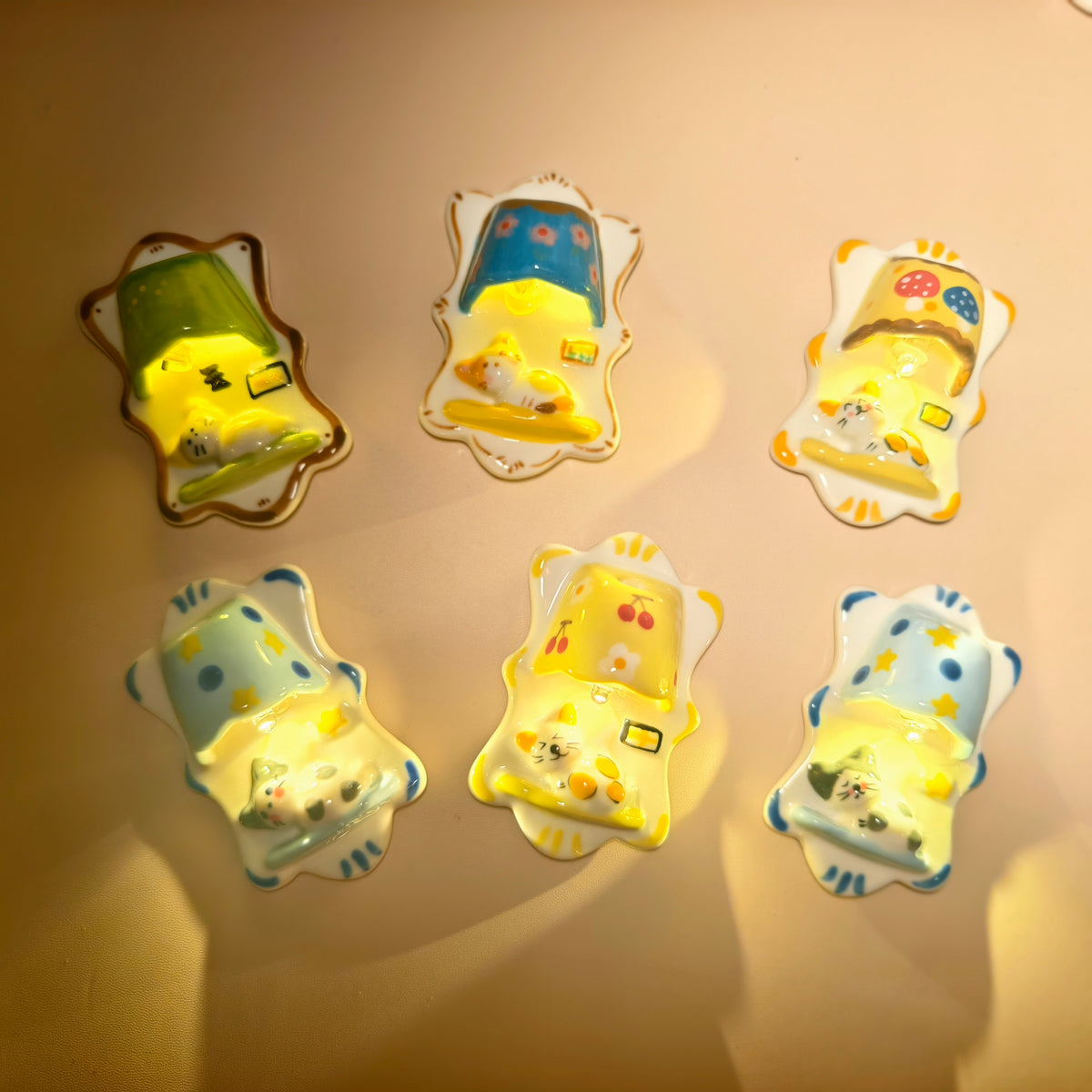 Six ceramic cat magnet lights illuminated