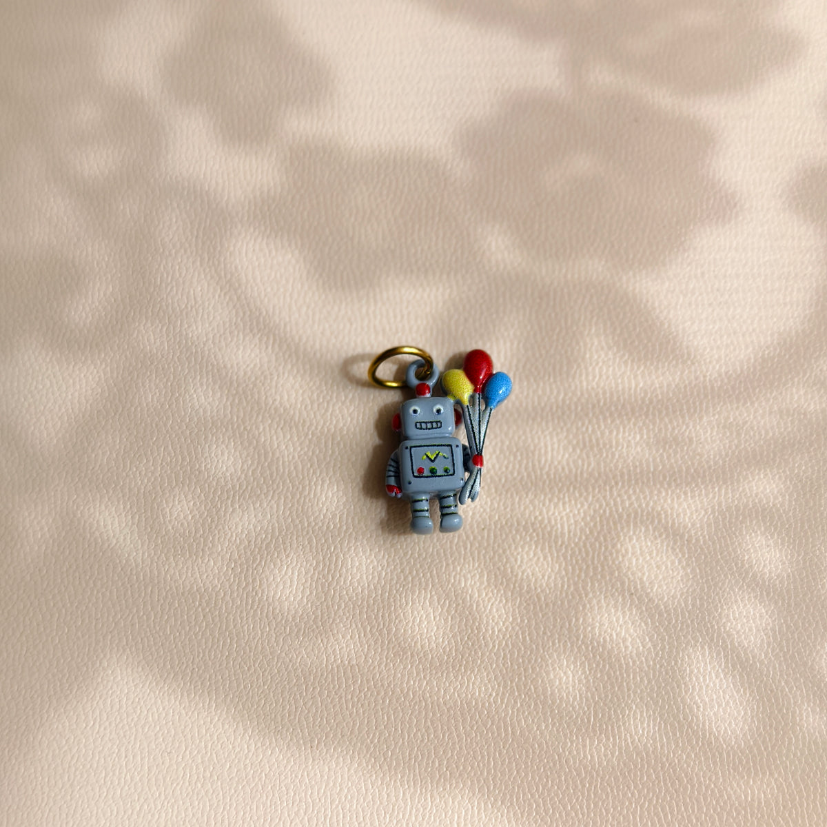 Grey Balloon Bearer Robot stainless steel charm holding yellow, red and blue balloons