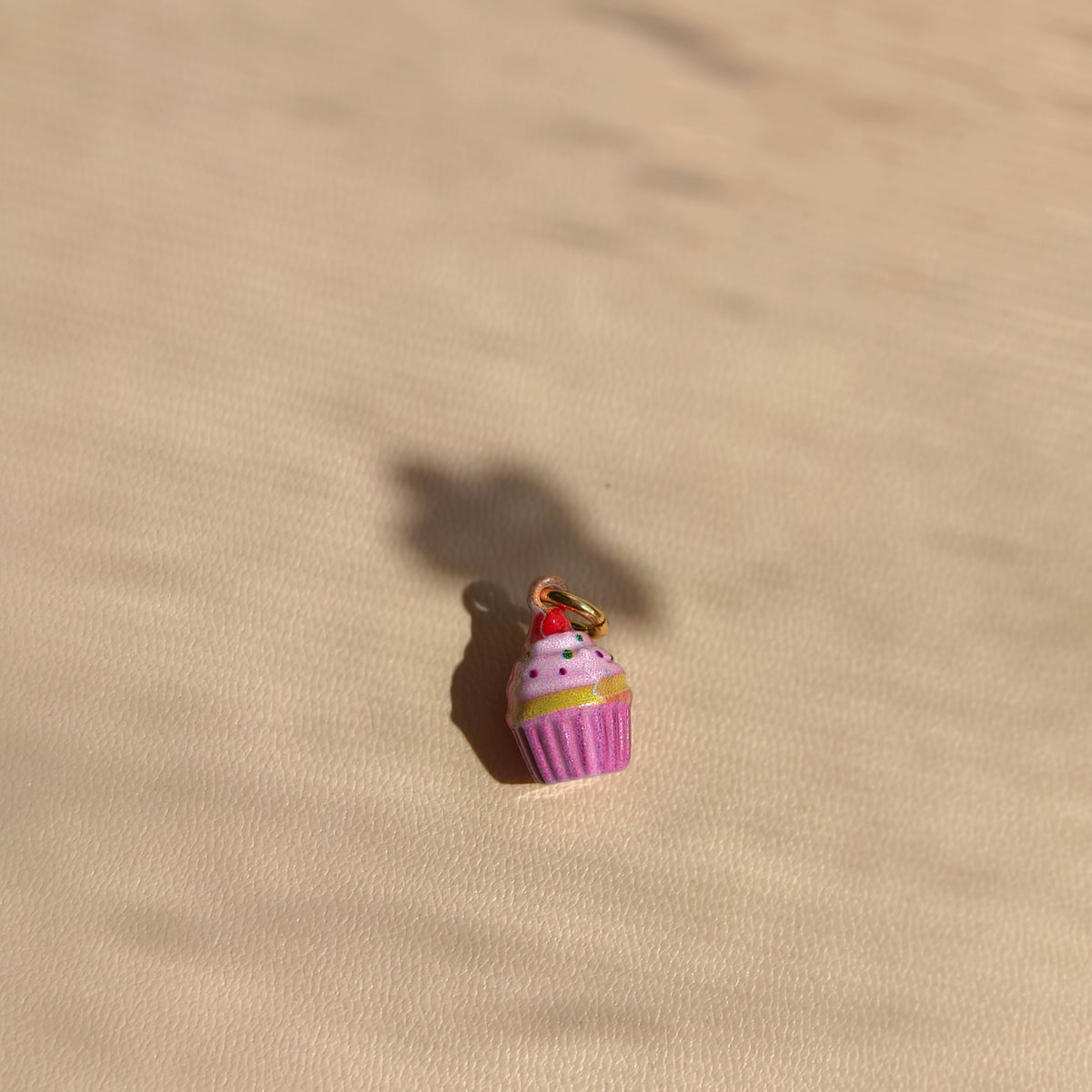 Pink Cupcake copper charm with pink frosting, sprinkles and a cherry