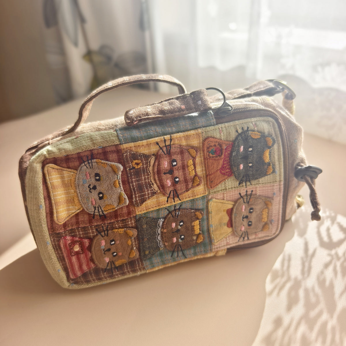 Side view showing drawstring opening, front zip and permanent side carry handle