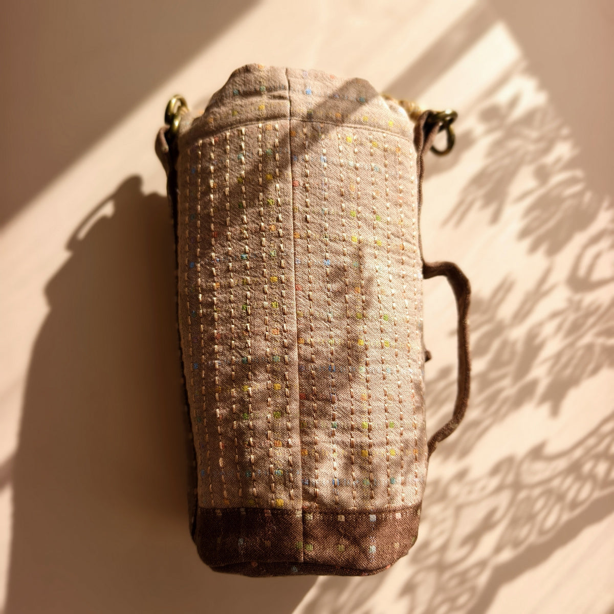 Plain warm taupe speckled back with stitched texture