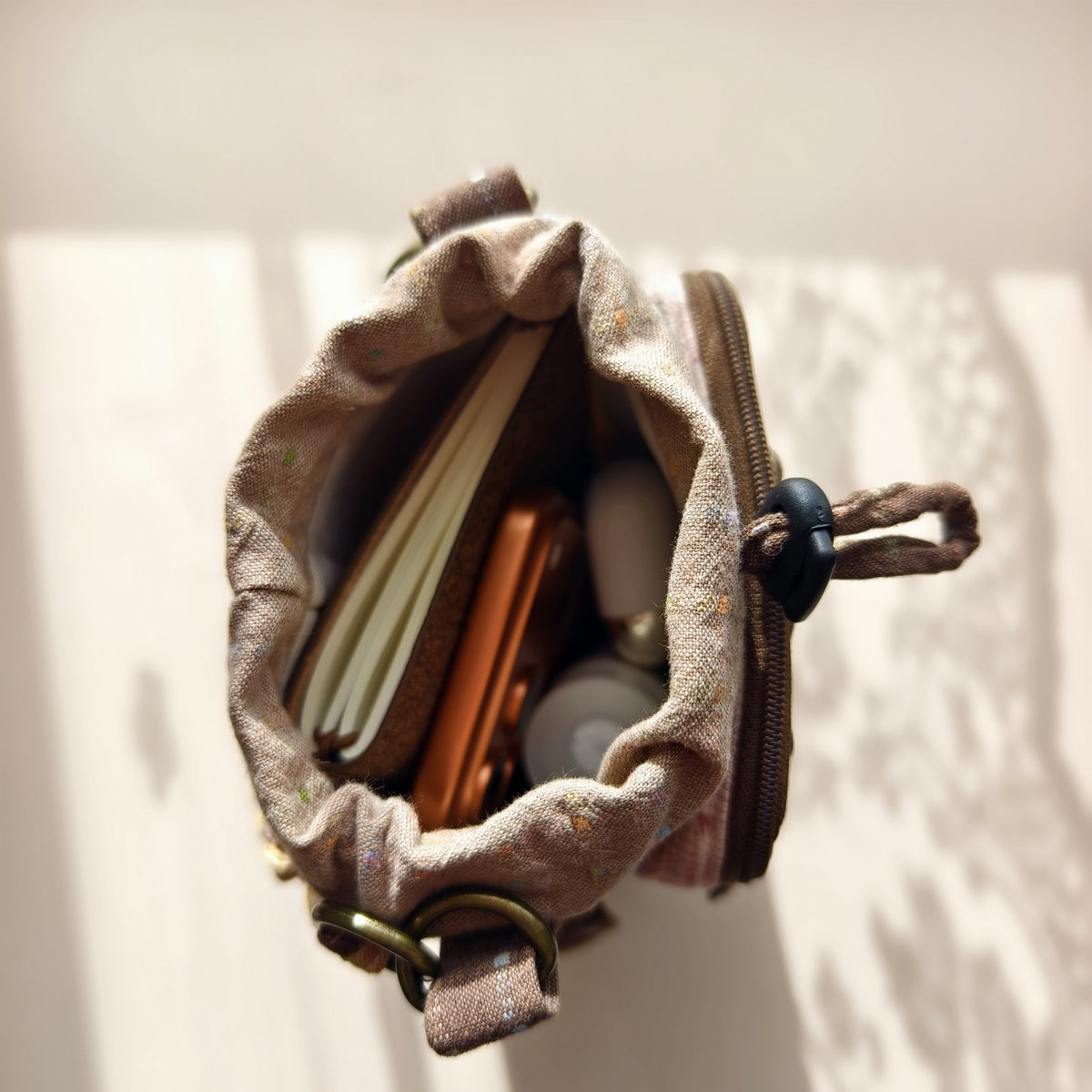 Actual main compartment holding small everyday essentials; contents not included