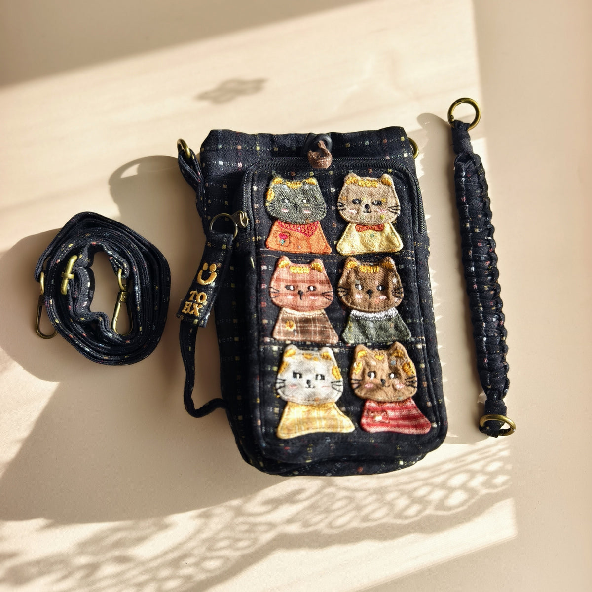 Actual navy cat bottle bag with included short handle and adjustable long strap