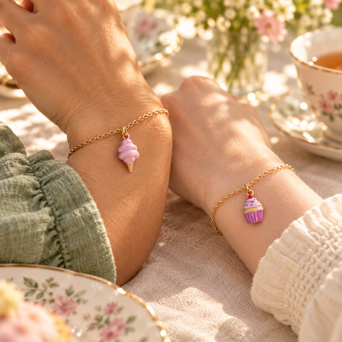 Pink Soft Serve and Pink Cupcake charms attached to separate gold-tone bracelets