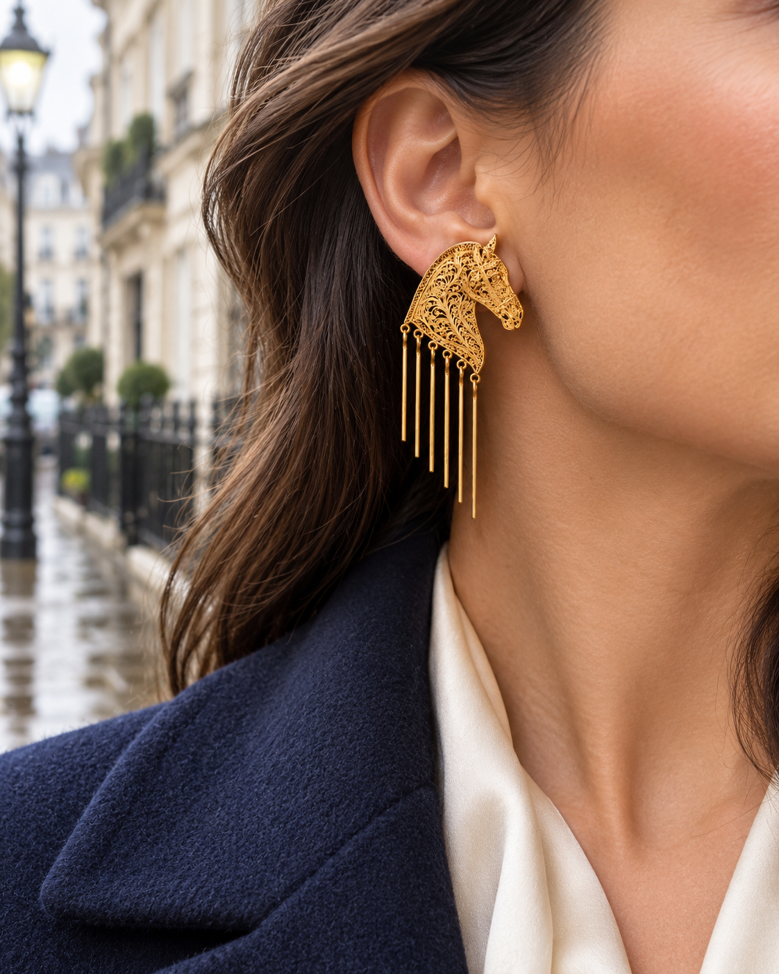 Baroque warhorse tassel earring worn with a tailored navy coat