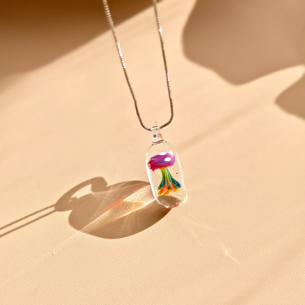 Lanterns Beneath the Tide – Glass Jellyfish Pendants